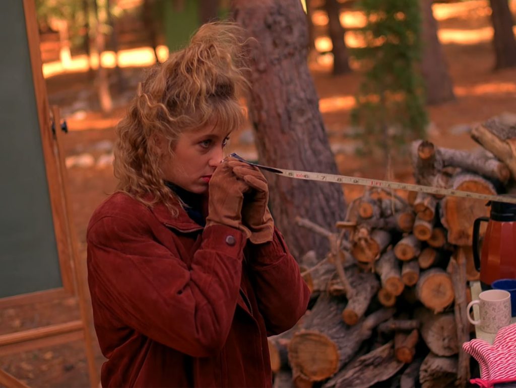 Lucy Moran holding up measuring tape to her nose
