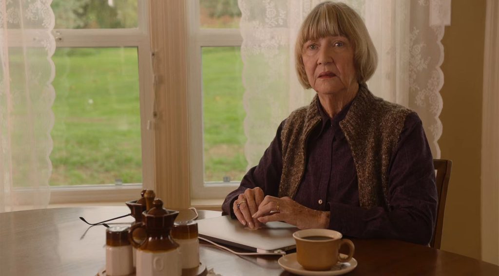 Betty Briggs sitting at a table with a computer