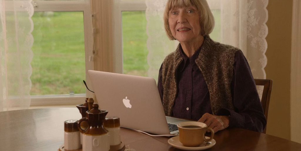 Betty Briggs sitting at a table with a computer