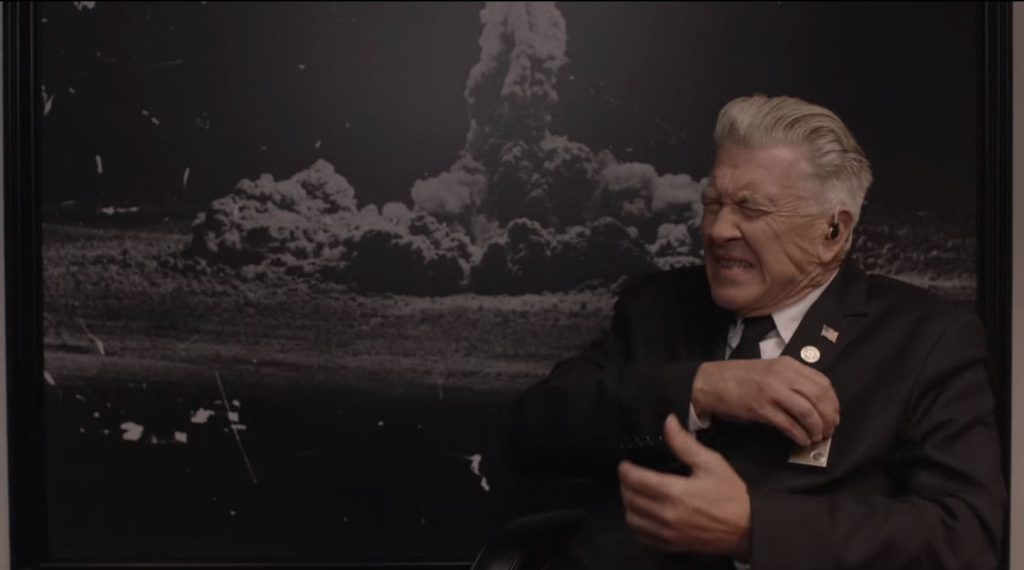 Gorden Cole adjusting his hearing aid device