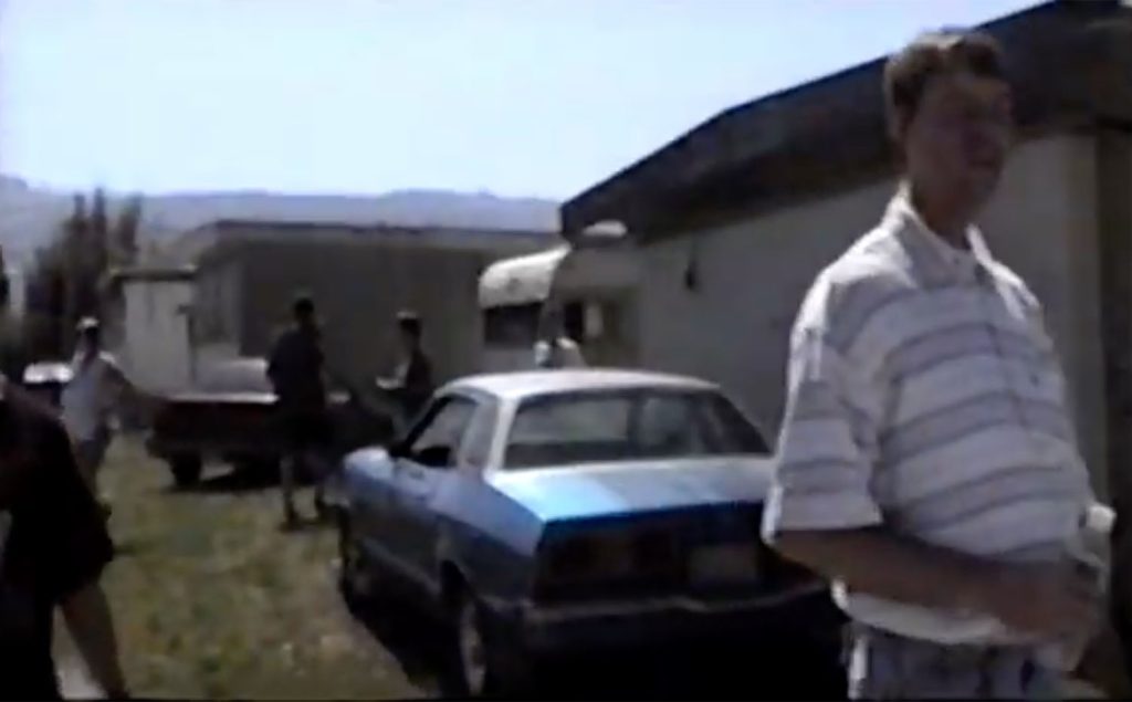 Blue car parked in trailer park