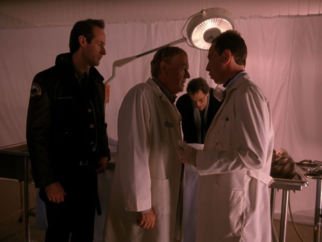 Albert Rosenfield confronts Dr. Hayward while Andy Brennan watches