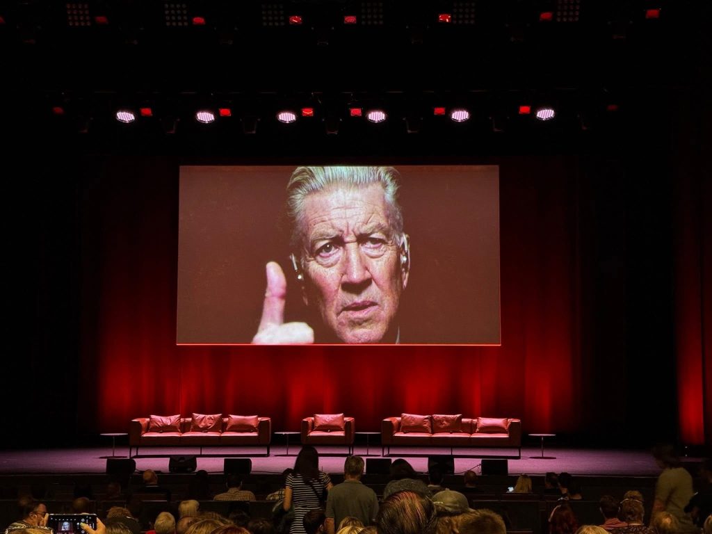 David Lynch on a movie screen in a theatre
