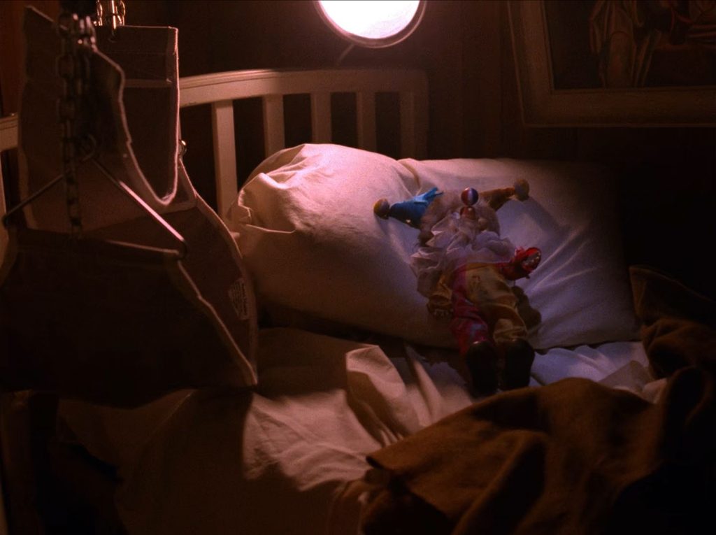 Bed with a clown doll