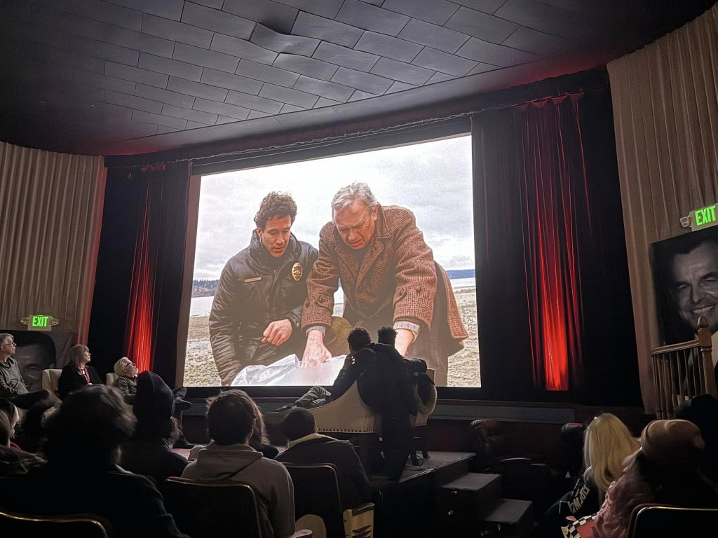 Movie theatre with audience watching a screen
