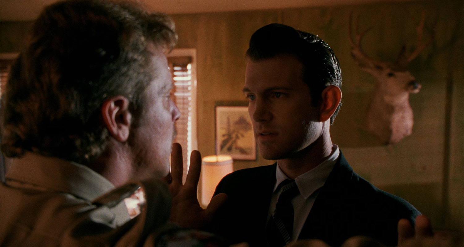 Agent Desmond grabbing Deputy Cliff's nose