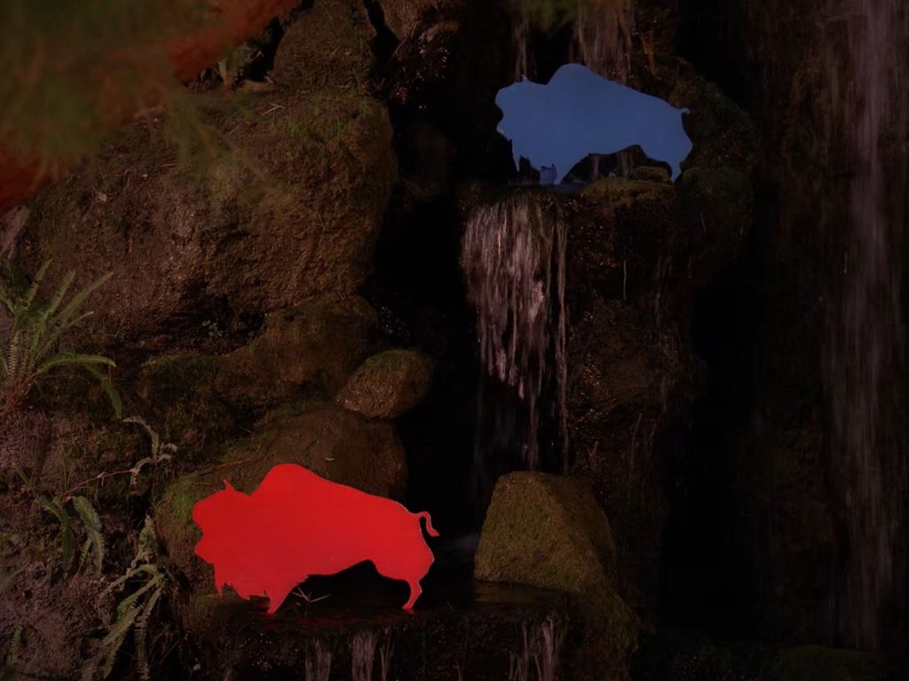 Red and blue buffalo cutouts on rocks
