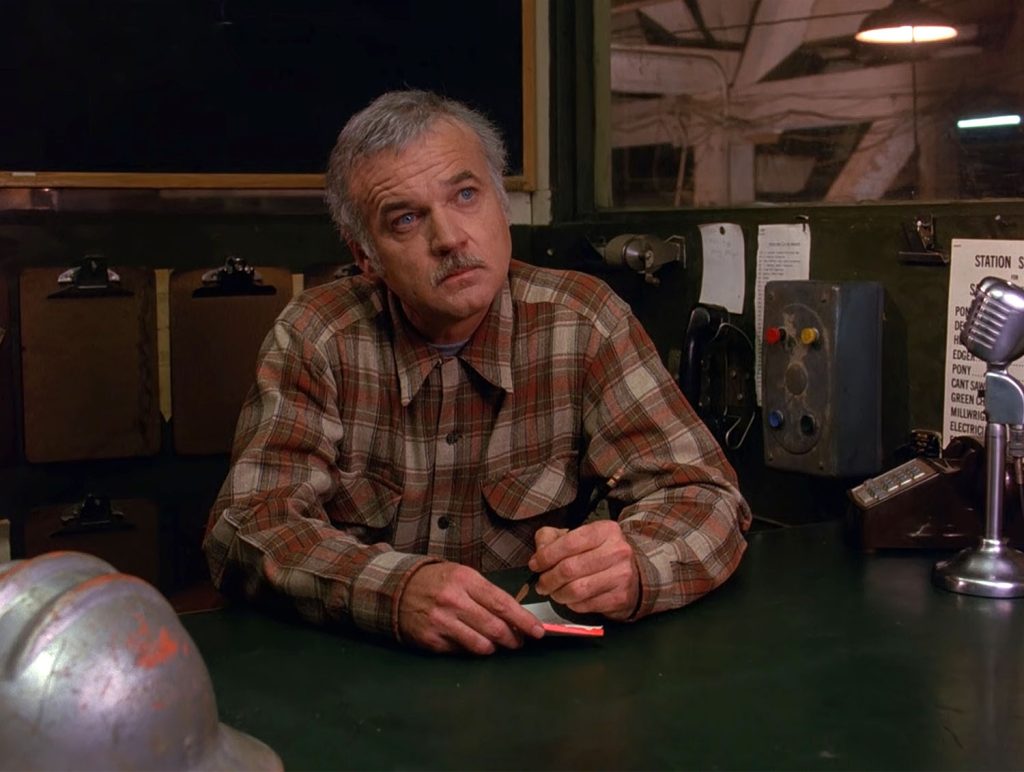 Pete Martell counting wood in the mill office