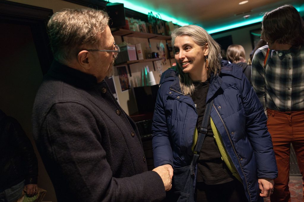 Richard Green meeting people in the lobby