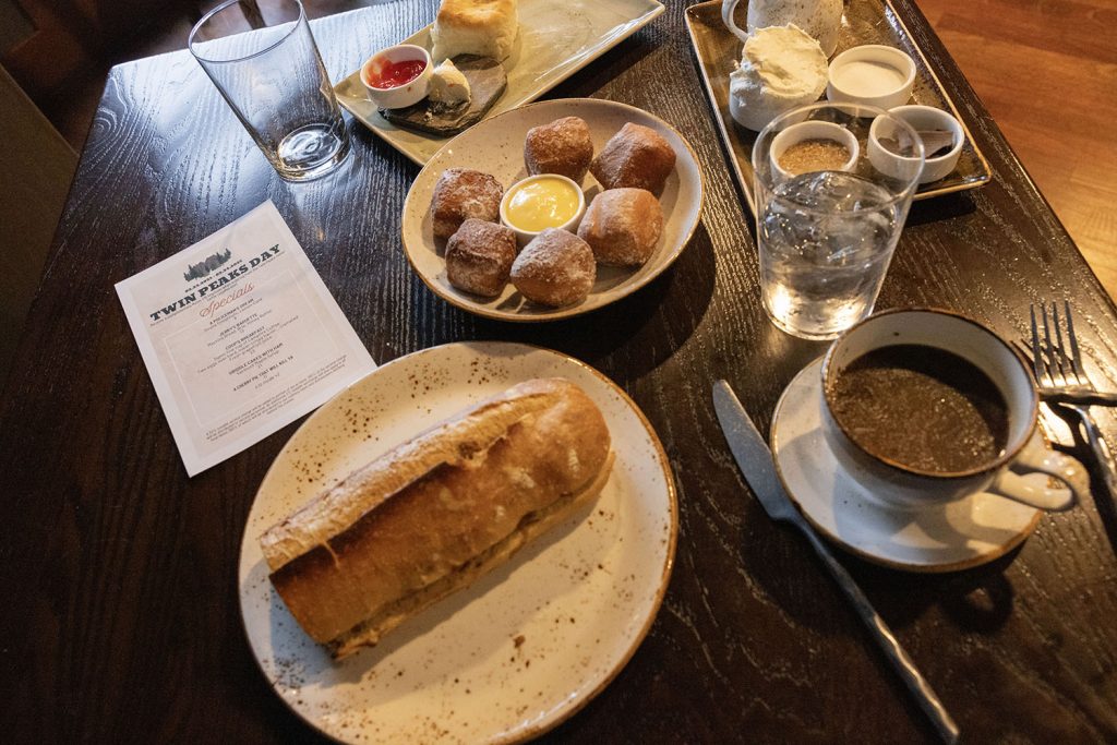 Table in Dining Room filled with breakfast food