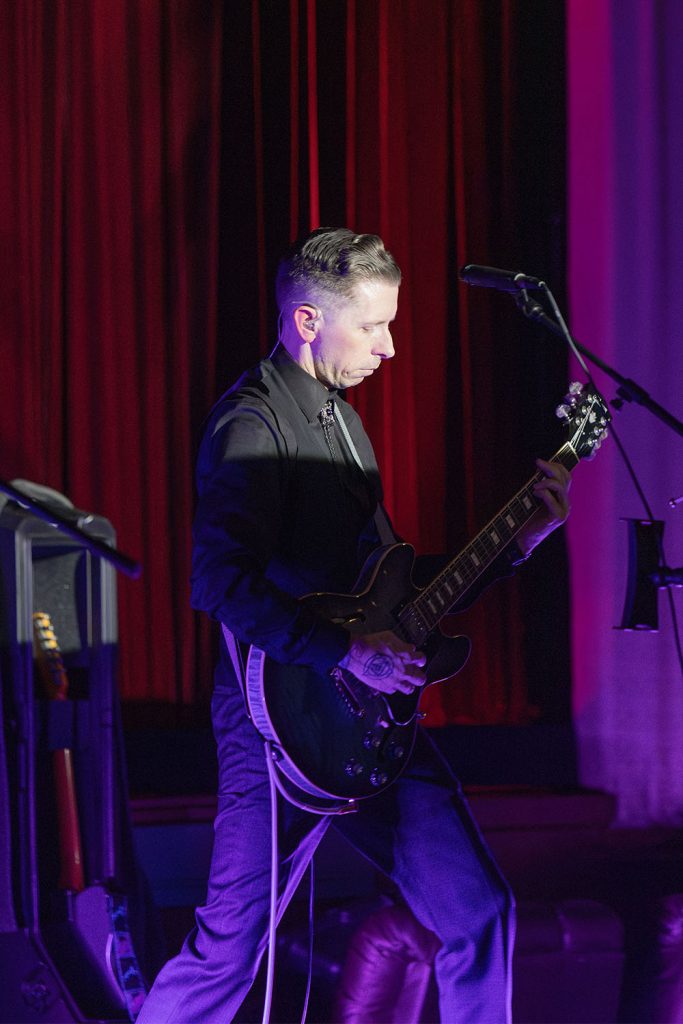 Dusty Highway playing guitar on stage at the North Bend Theatre