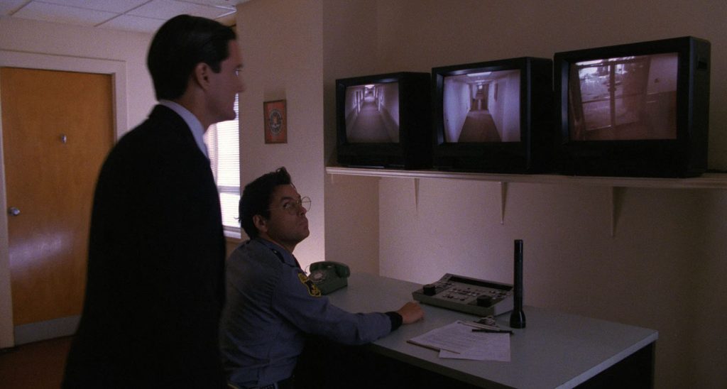 Guard and Cooper looking at screens