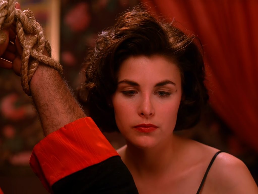 Audrey Horne looking down at Emory Battis
