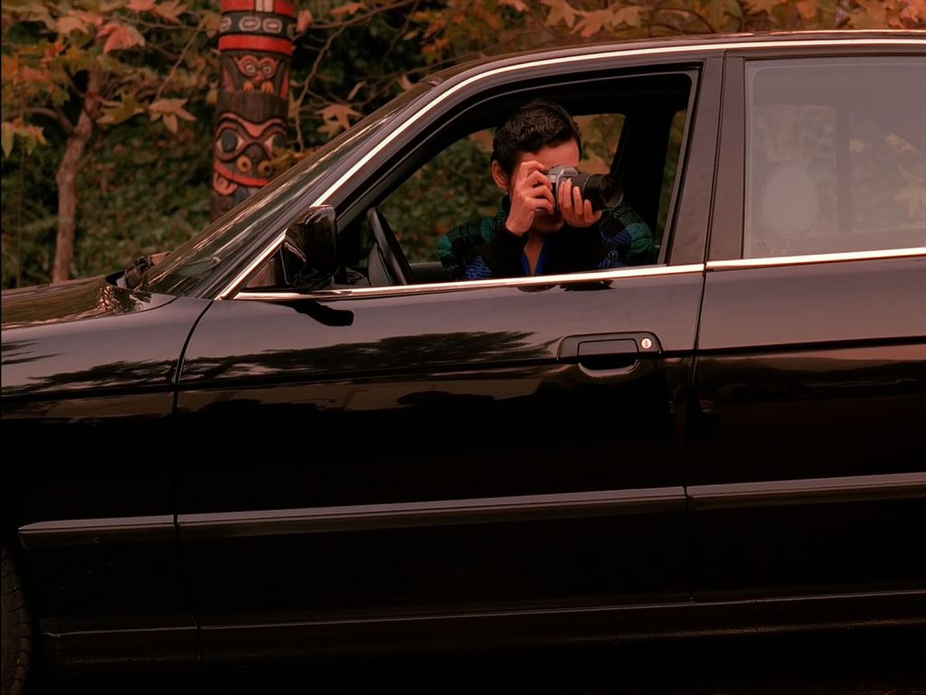 Josie Packard taking photos with a Nikon camera from her car