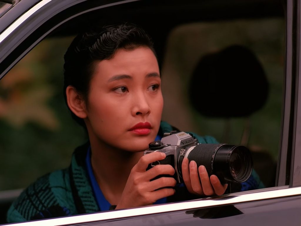 Josie Packard taking photos with a Nikon camera from her car
