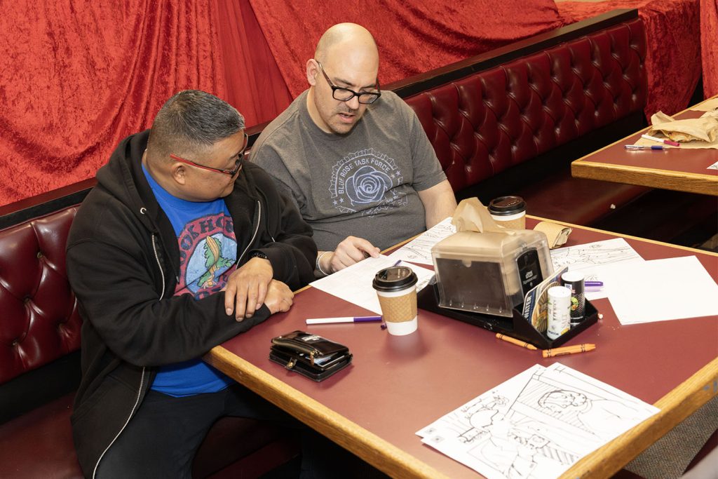 Two people looking at activity sheets