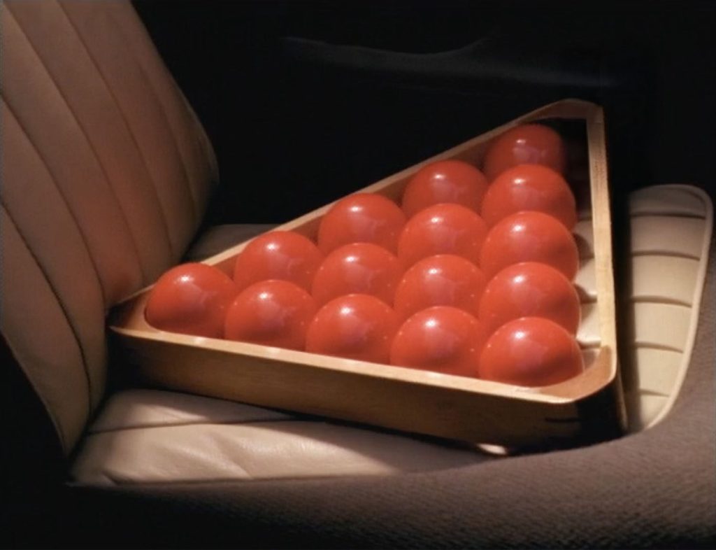 Rack of 15 red Snooker balls on a car seat