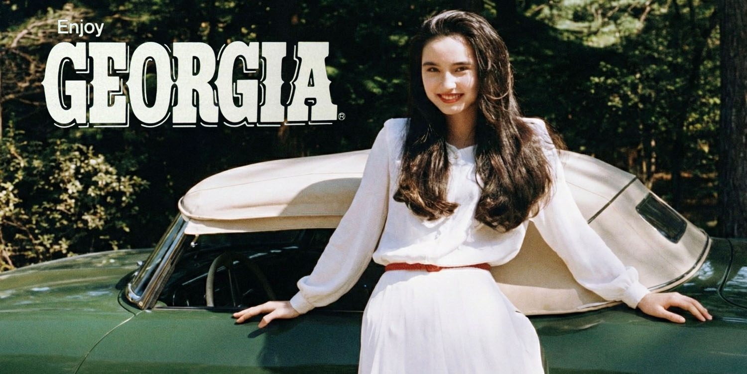 Asami standing next to a car with the "Enjoy Georgia" logo