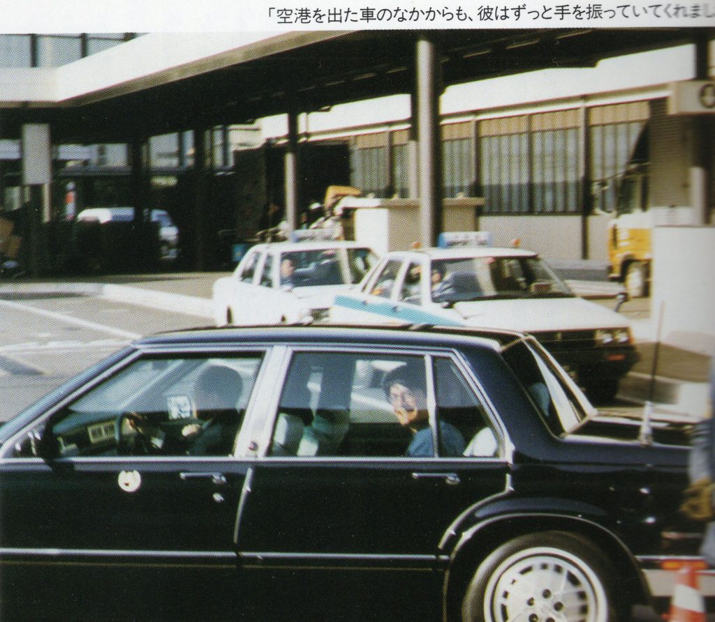 Kyle MacLachlan riding in the backseat of a car