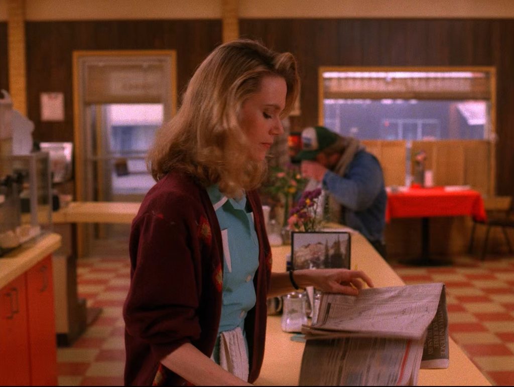 Norma Jennings holding a newspaper