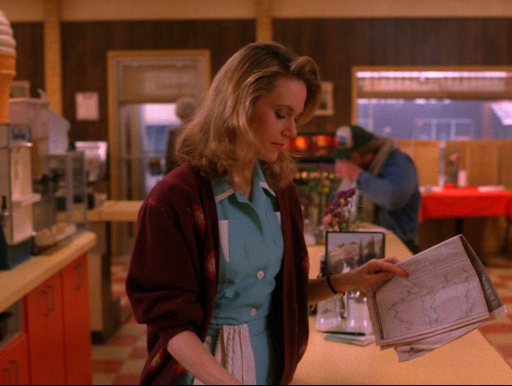 Norma Jennings holding a newspaper