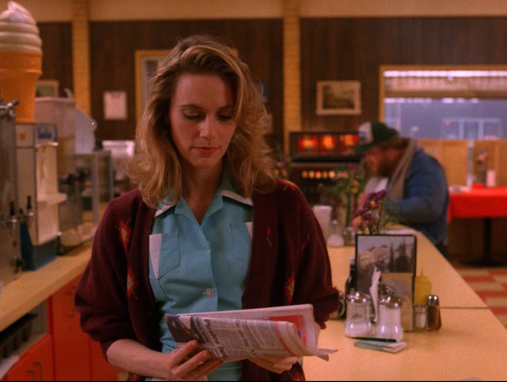 Norma Jennings holding a newspaper