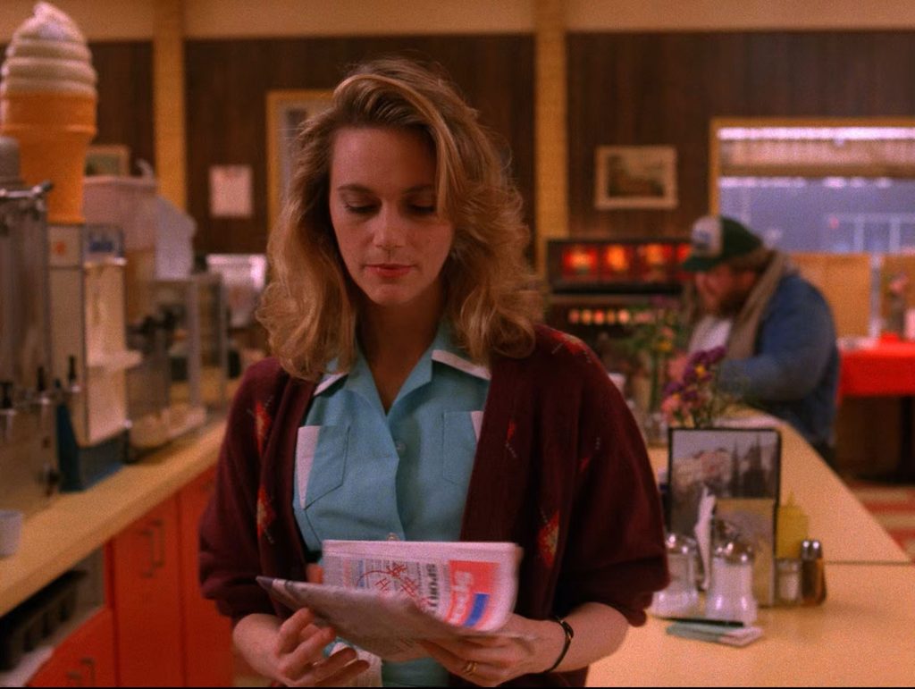 Norma Jennings holding a newspaper