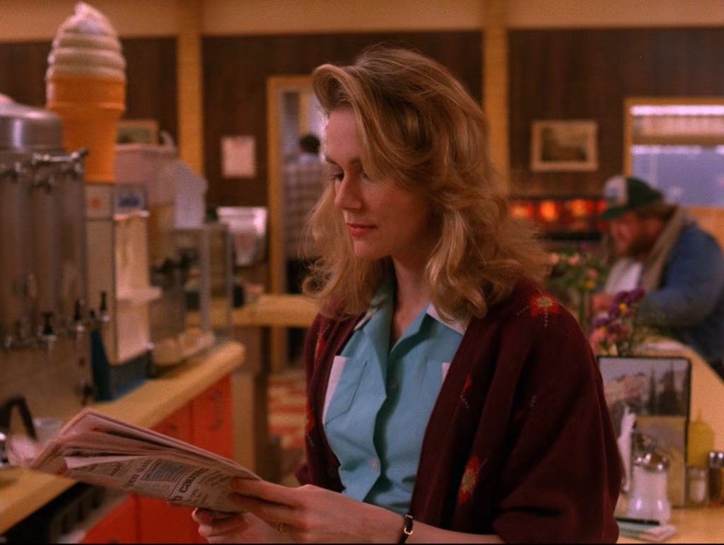 Norma Jennings holding a newspaper