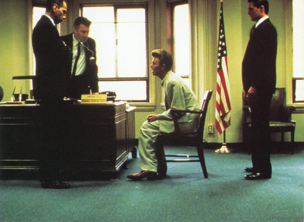 Agent Phillip Jeffries speaks to Gordon Cole, Dale Cooper and Albert Rosenfield