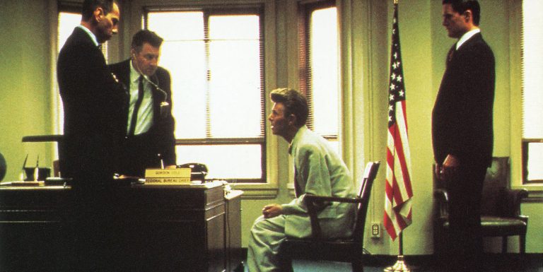 Agent Phillip Jeffries speaks to Gordon Cole, Dale Cooper and Albert Rosenfield