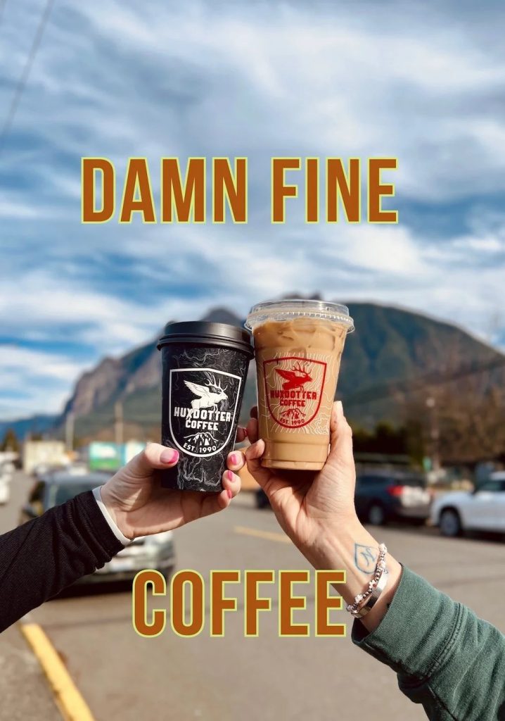 Two people holding Huxdotter Coffee