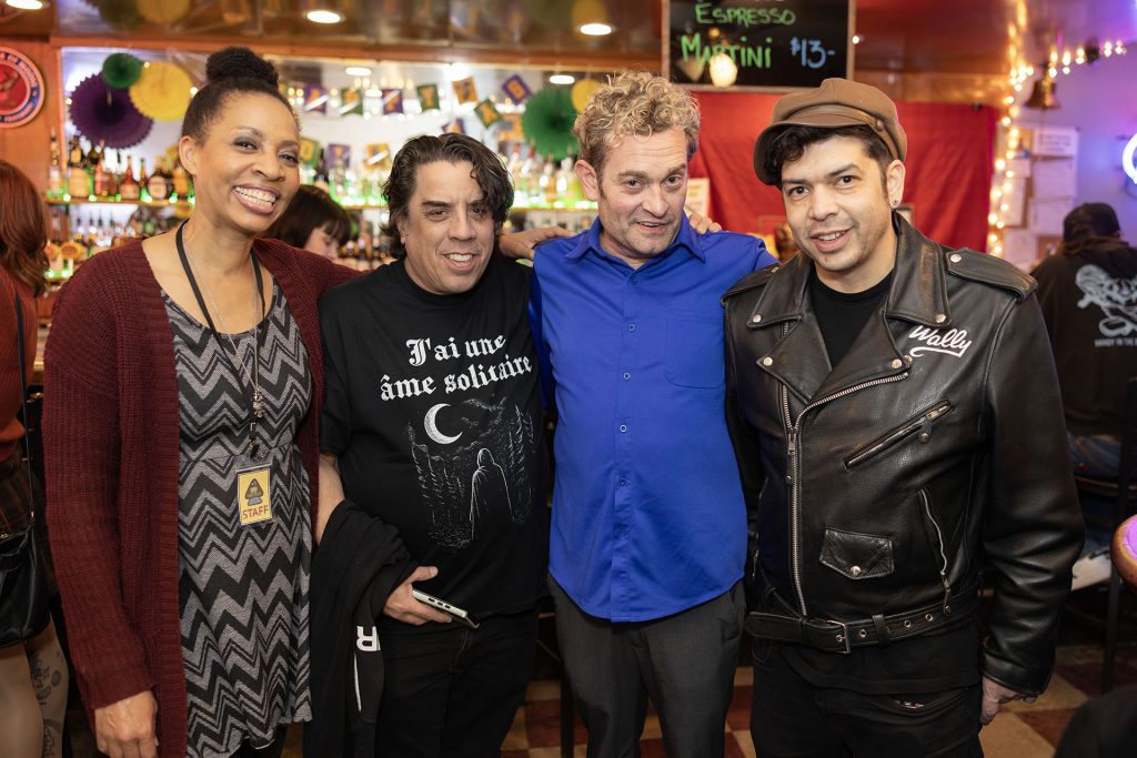 Line of people standing in a bar