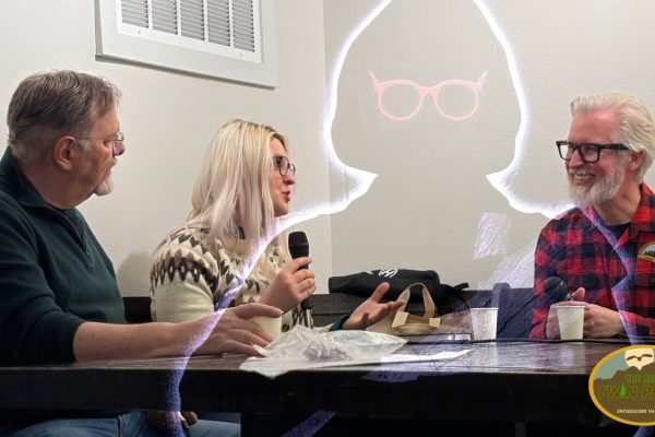 Richard Green, Alex Shurun and Steven Miller at a table with a drawing of Catherine Coulson as the Log Lady floating in the background