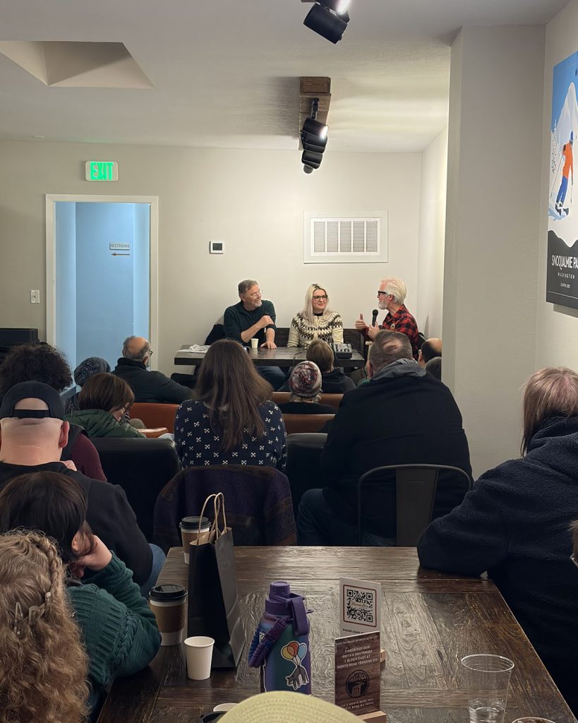 Packed room with panel discussion at the front