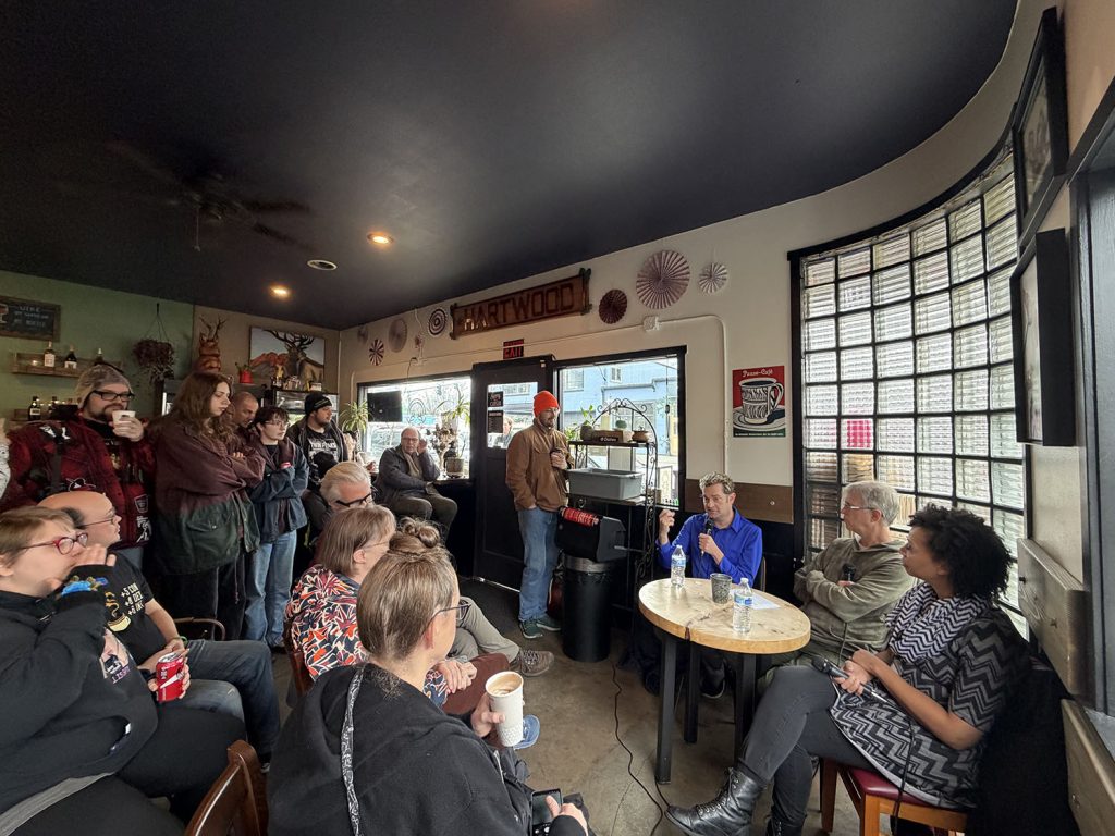 Attendees standing and sitting in Hartwood Cafe 