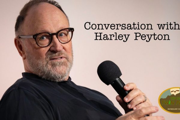 Harley Peyton on stage holding a microphone