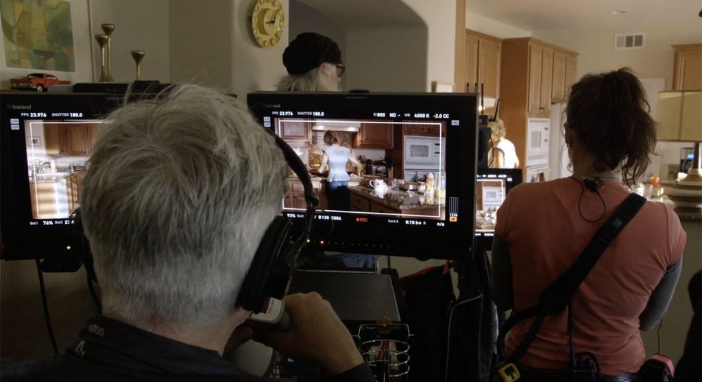 David Lynch looking at two monitors