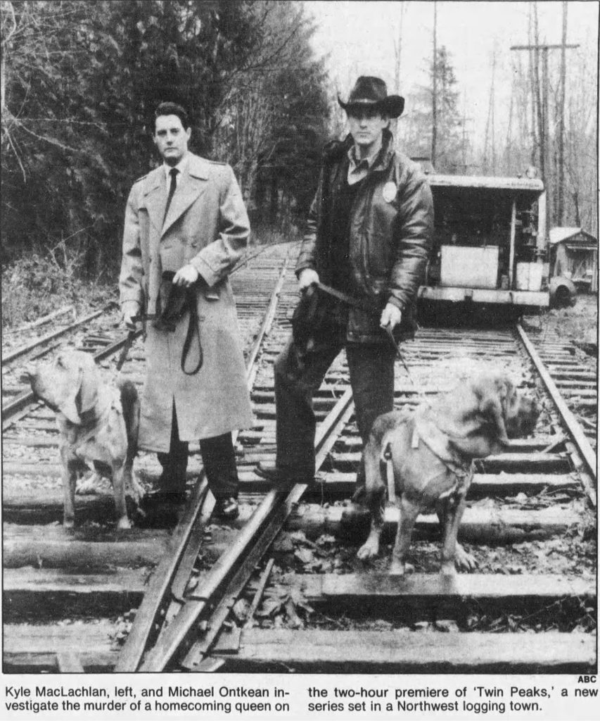 Sheriff Truman and Agent Cooper with dogs on a railroad track