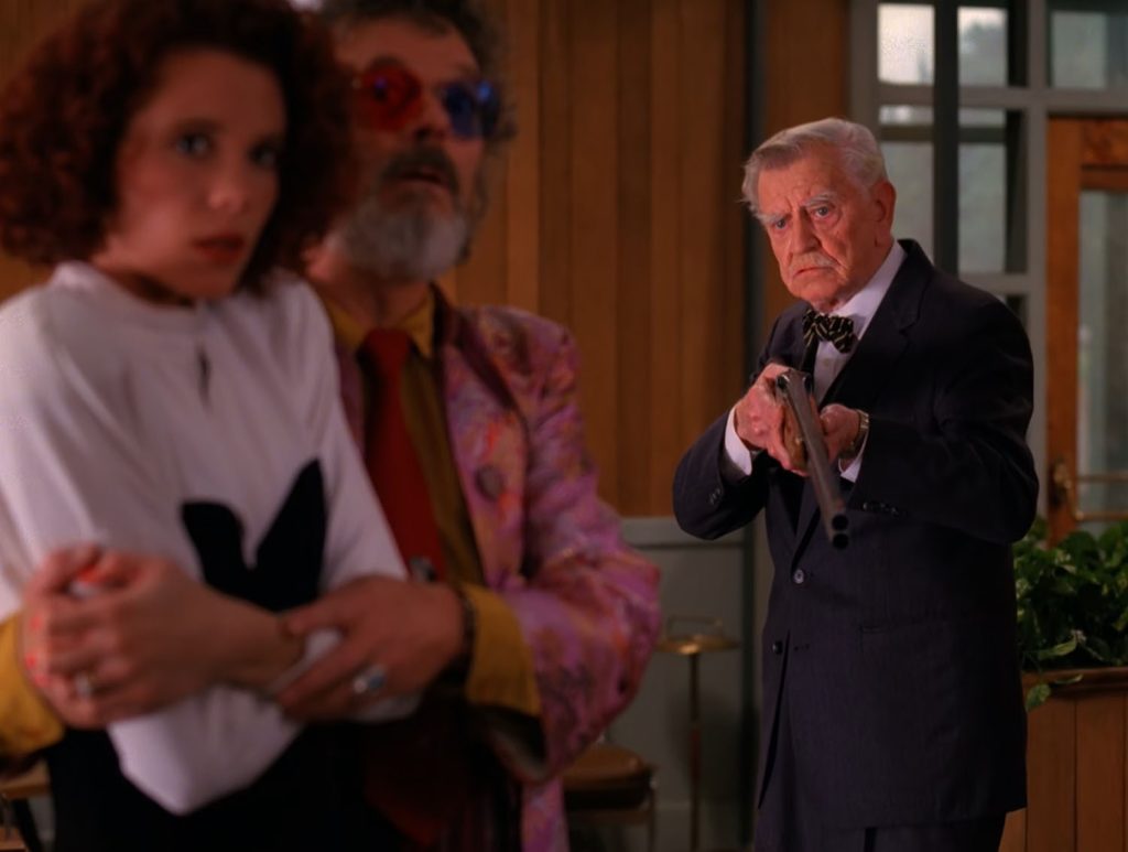 Mayor Milford pointing a gun toward Dr. Jacoby and Lana