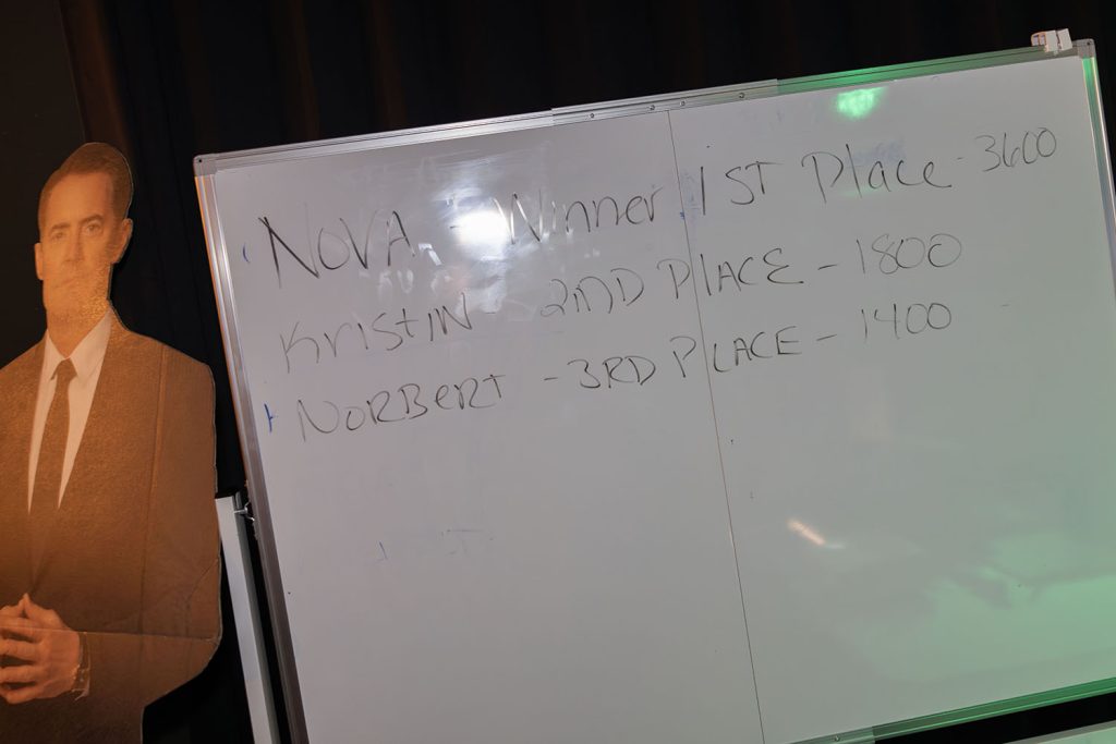 Final scores written on a dry erase board