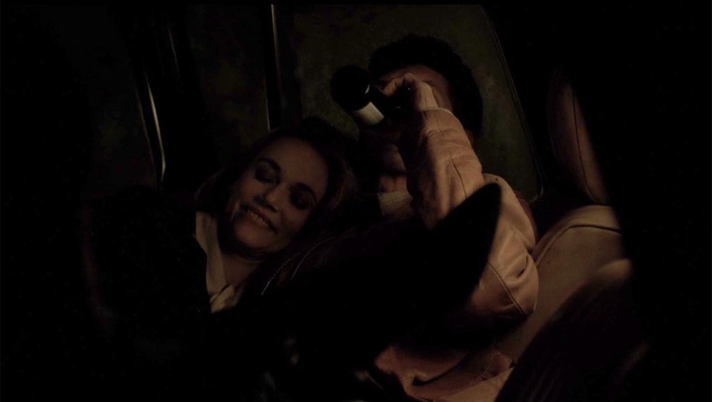 Big Ed drinking a beer while Norma lays on his chest