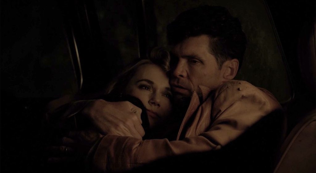Ed pulls Norma closer during a tender moment in his truck