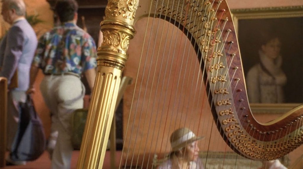 Harp with a bellhop walking in the background