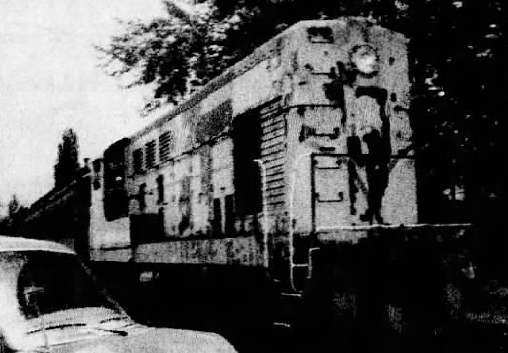 Black and white photo of a rusted train car