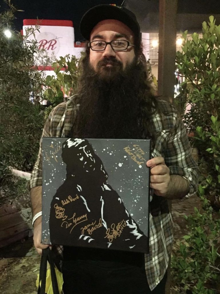 Vinnie Guidera holding a painting