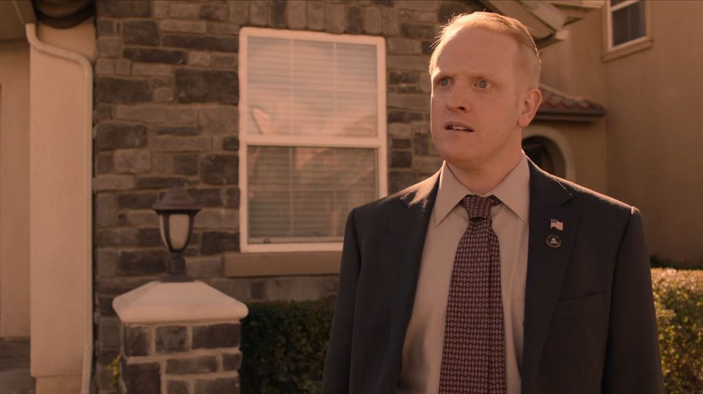 Agent Wilson standing outside a home