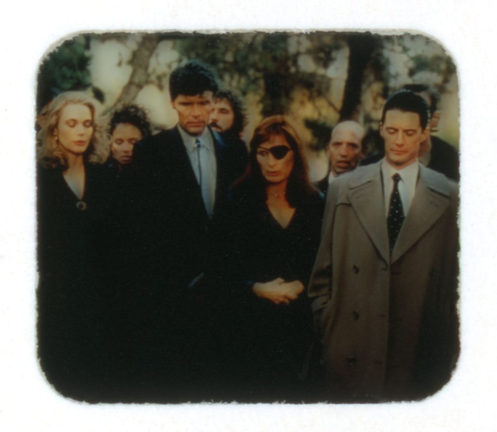 Laura Palmer's funeral with people standing near her grave