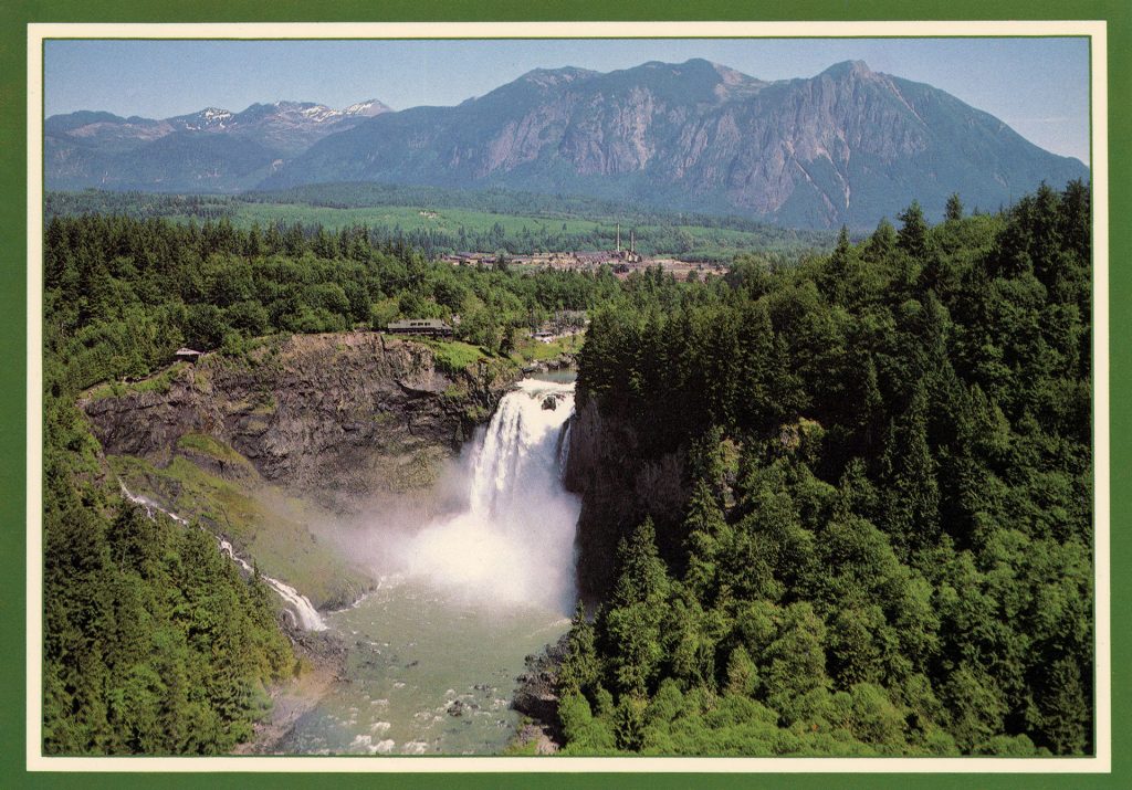 Front of Snoqualmie Falls & Lodge postcard with an aerial view of the waterfall, hotel and Mount Si