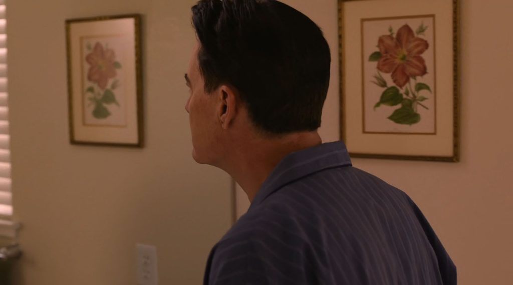 Dougie Jones approaching a bathroom mirror