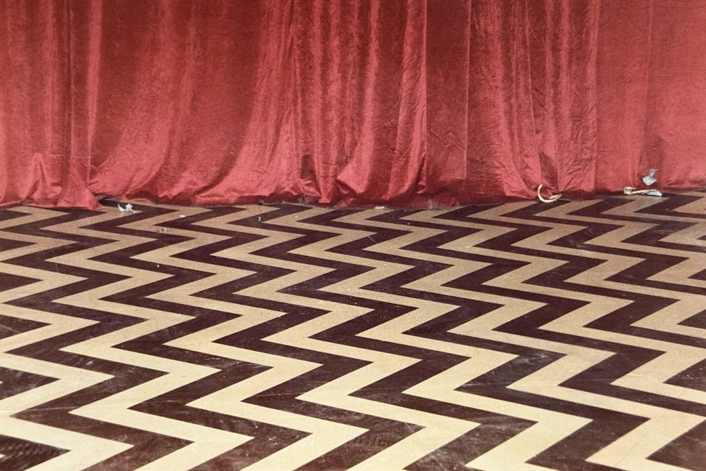 Polaroid photo of Black Lodge chevron floor and red curtains